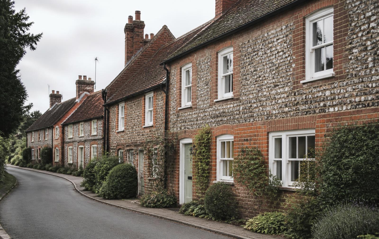Traditional Norfolk brick and flint cottages on a village lane near Norwich
